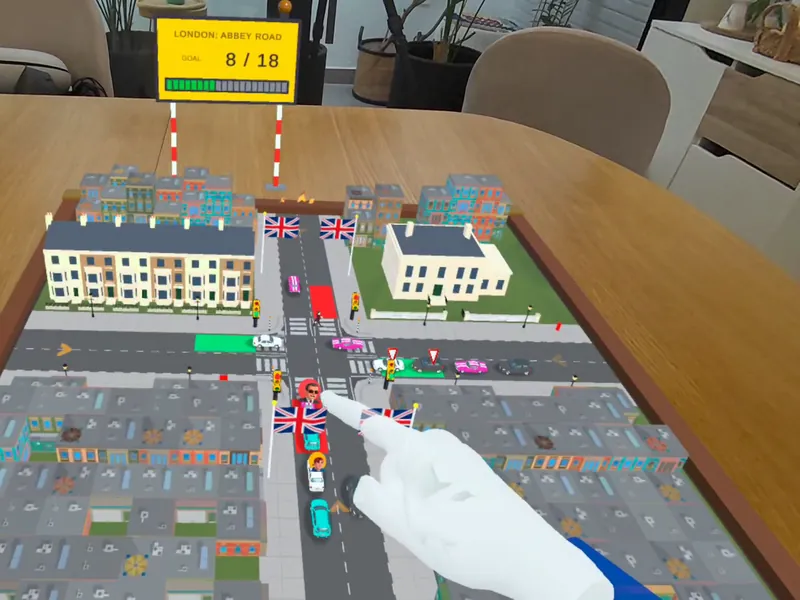 Abbey Road en miniatura sobre una mesa de comedor, con una mano señalando un cruce